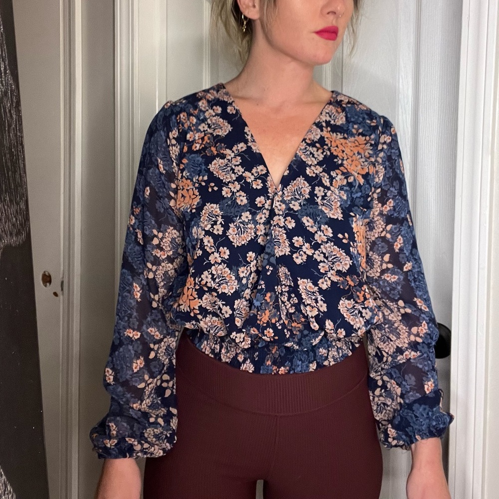 Long sleeve floral blouse with sheer sleeves.
